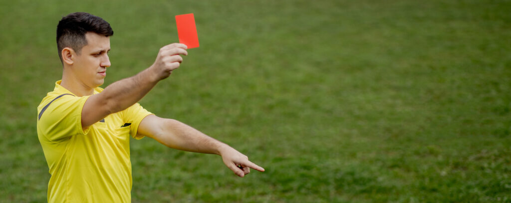 Football referee showing a red card