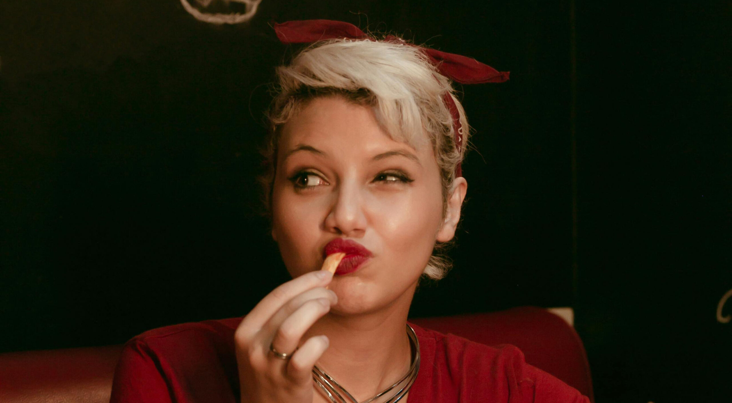 Lady eating a chip with Hienze sauce