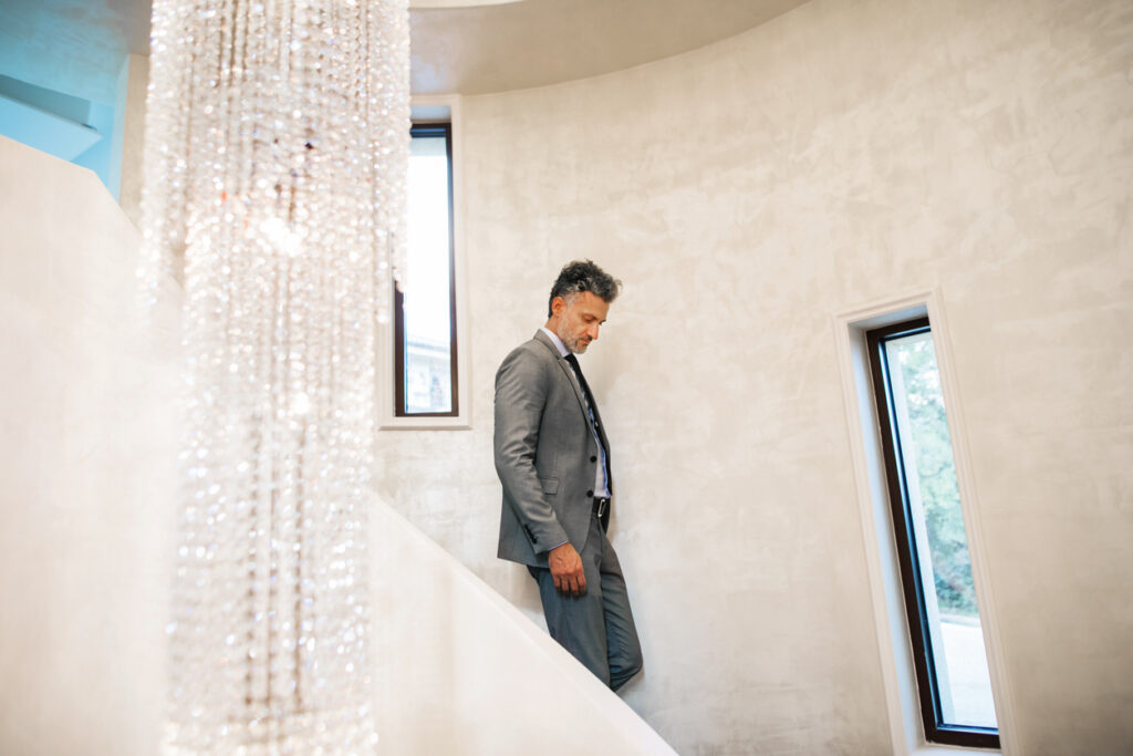 Mature man wearing a suit in a setting that typifies modern luxury