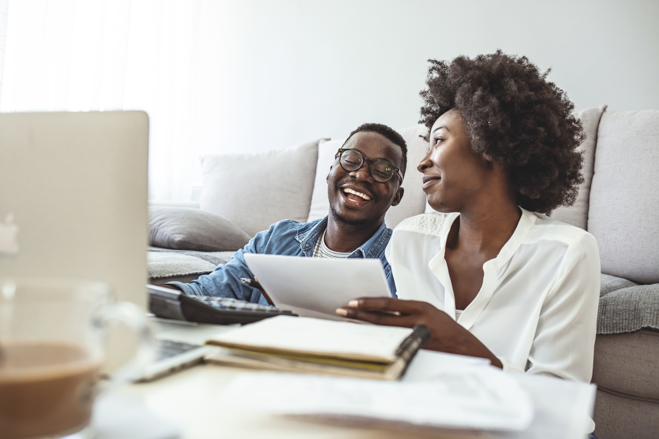 young couple doing their financial planning using laptop